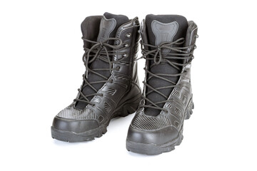 Black military combat boots with laces and rugged soles, front view on white background. Durable and sturdy footwear designed for outdoor activities and tactical use