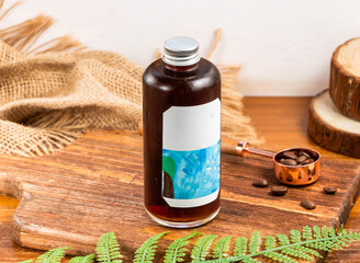 Cold Drip Coffee served in bottle isolated on wooden table side view of taiwan drink