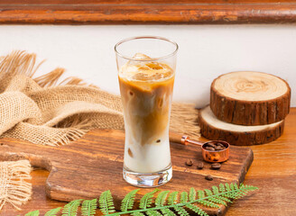 Latte served in glass isolated on wooden table side view of taiwan drink