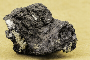 Macro photo of a dark mineral specimen showing fibrous structure and metallic sheen. Useful for geology, earth science, mineralogy, or educational purposes in stock photography