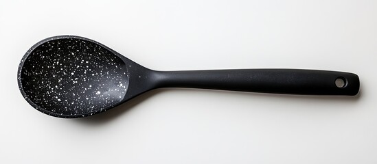 Black speckled serving spoon isolated on white background. (1)