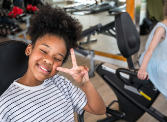 Curly hair black girl doing exercise in fitness