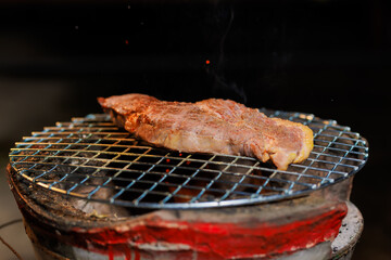 A perfectly grilled beef steak rests on a hot barbecue grill, ready to be served at a lively outdoor party or festive gathering.