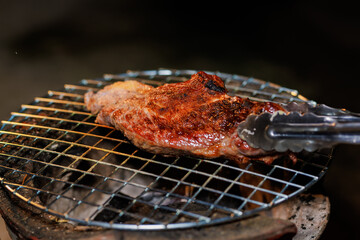 A perfectly grilled beef steak rests on a hot barbecue grill, ready to be served at a lively outdoor party or festive gathering.