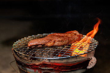 A perfectly grilled beef steak rests on a hot barbecue grill, ready to be served at a lively outdoor party or festive gathering.