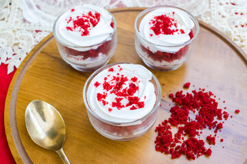 Red Velvet Mini Cakes in Glass Jars on Wooden Tray. Elegant Dessert Layout with Red Background. festive vibes, gourmet styling, and creative plating, perfect for food blogs, bakery promotions