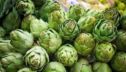 Close-up of fresh organic artichokes displayed at a local weekend market, showing texture, natural color, and freshness of seasonal vegetables.