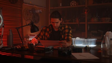 Analog Photography Darkroom Process with Red Lighting Ambiance