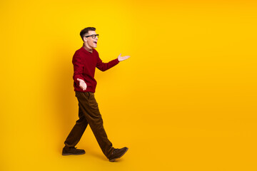 Young Handsome Man Gesturing Passionately Against a Bright Yellow Background