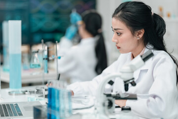 Medical research team conducting scientific experiments in a pharmaceutical laboratory, analyzing...