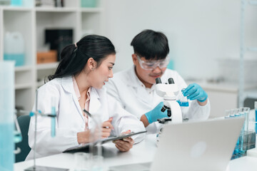 Research team working in medical science laboratory to develop innovative cosmetic products through precise analysis experimentation, technology with collaborative scientific methods