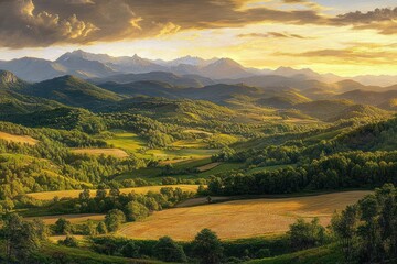 Obraz premium Expansive rolling green hills and golden fields under a dramatic sunset sky with layered mountain ranges in the distance, creating a serene and peaceful natural landscape