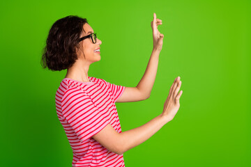 Smiling Woman in Striped T-shirt Gesturing Enthusiastically Against Bright Green Background