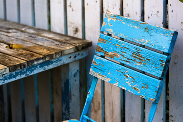 old wooden fence and blue rustic chair