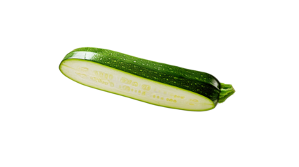 A halved zucchini with visible seeds and flesh lying on a plain transparent surface in a studio shot