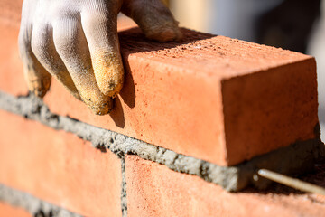 Crafting Endurance A Close-Up View of Bricklaying and Construction Precision