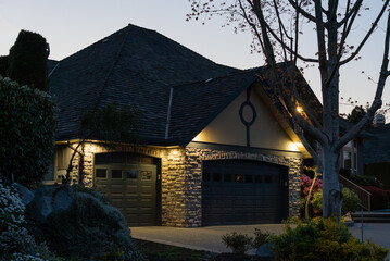 Garage door in luxury house with trees and nice landscape in Spring in Vancouver, Canada, North...