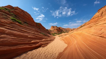 Gardinen Breathtaking panoramic view of vibrant red sandstone formations sculpted by time, creating a stunning desert landscape under a clear blue sky with white clouds. © MasTPX