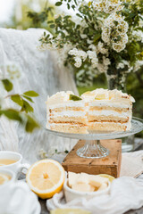 A delicate arrangement of citrus sponge cake with silky white chocolate glaze, styled with lace...