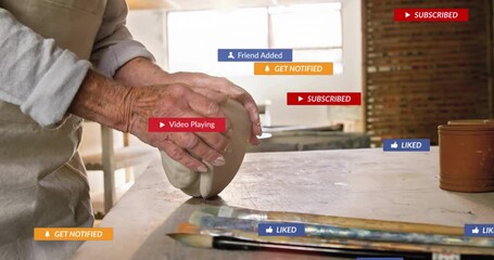 Senior potter shaping wet clay in pottery workshop, showing floating social media notifications - Powered by Adobe