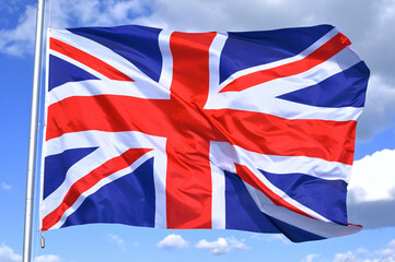 Fototapeta premium Close-up of the national flag of United Kingdom, Great Britain, fluttering in the wind, wave pattern