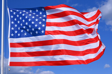 Fototapeta premium Close-up of the national flag of United States fluttering in the wind, wave pattern