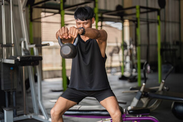 Kettlebell Workout. Man lifting kettlebell in gym for functional fitness and strength.
