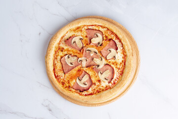 Ham & Mushroom Pizza – Classic pizza with ham and champignons on a cheesy tomato base. Served on a wooden board over white marble for a clean, minimal look.