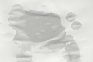 Blank wet sheet of paper. Wet spot on paper. Wet office paper
