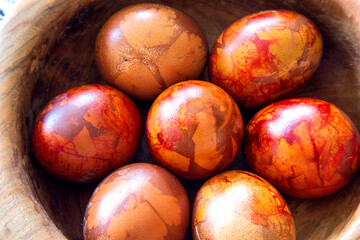 Easter colored eggs in the bowl on the table. Top view
