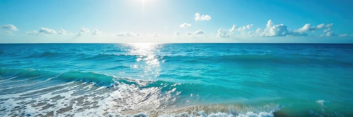 Fototapeta premium Vast expanse of deep blue ocean water, sunlit surface reflecting light, tranquil waves gently lapping the shore Perfect for travel, nature, and environmental themes , waves, oceanic, light