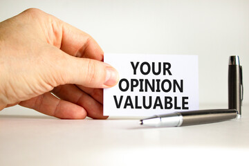 Your opinion valuable symbol. Concept words Your opinion valuable on beautiful white card. Beautiful white background. Businessman hand. Business your opinion valuable concept. Copy space.