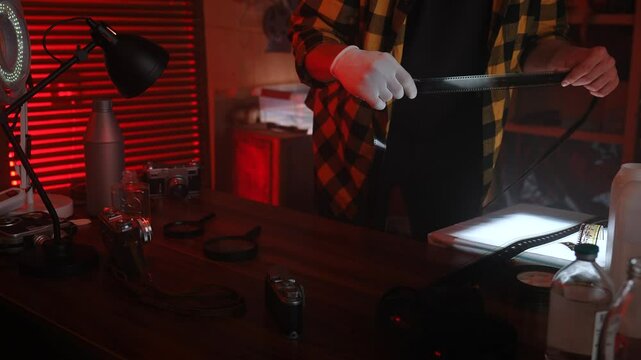 Person Working in a Darkroom Developing Film Photographs