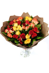 A beautiful bouquet of multi-colored roses packed in brown thick paper on a white background.