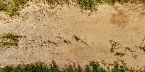 view from above on surface of texture of dry road with tractor tire tracks in countryside