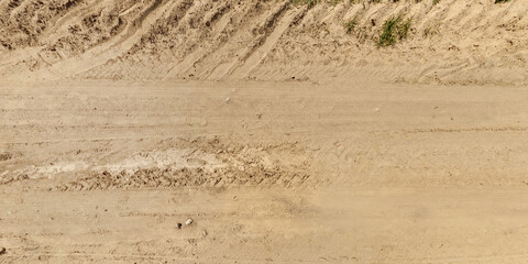 view from above on surface of texture of dry road with tractor tire tracks in countryside © hiv360