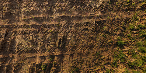 view from above on surface of texture of dry road with tractor tire tracks in countryside