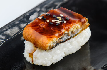 Grilled eel sushi with sweet sauce and sesame