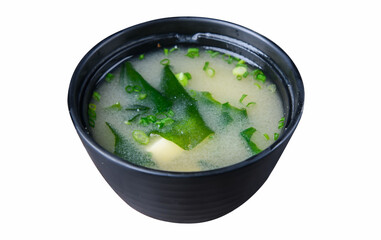 Miso soup with seaweed and tofu in black bowl