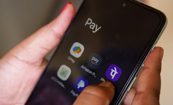 West Bengal, India - May 16, 2025: Gpay a money transferring by app for India through UPI. Woman using Google payment system and other UPI application like Amazon pay, Phonepe.