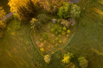 Aerial springtime view of an apple orchard with blossoming apple trees. Beautiful morning light illuminates this orchard as spring takes over with a promise of a bountiful apple harvest.