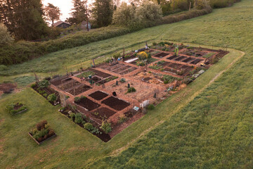 Aerial view of a Community garden located on an island in the Pacific Northwest. Beautiful morning light illuminates a garden area set aside on a land preserve in the Salish Sea area of Washington.