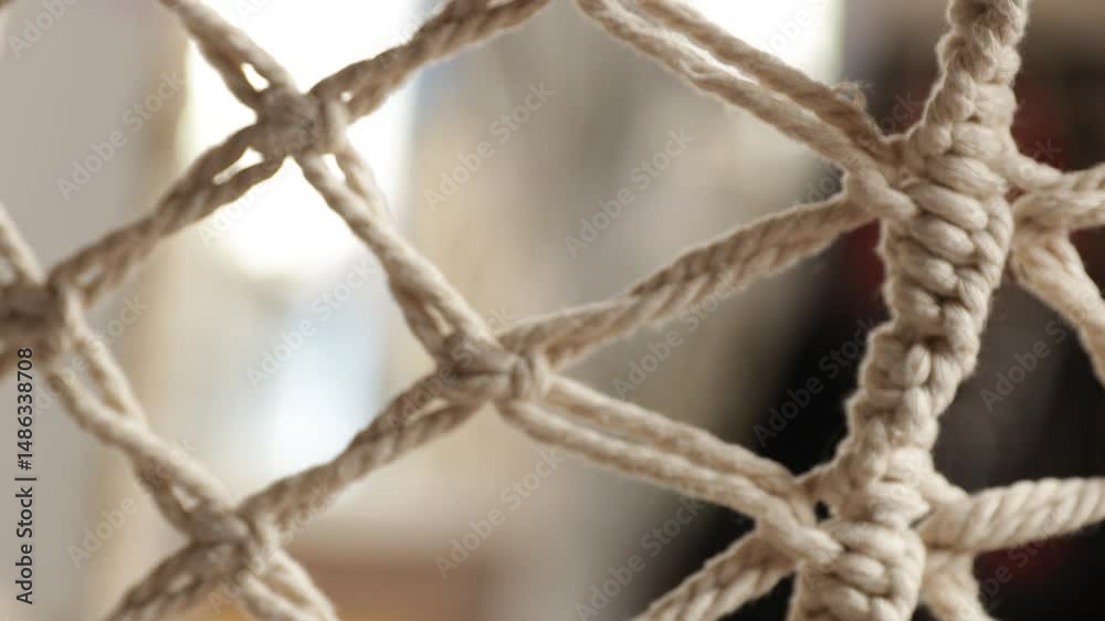 Aufkleber A close-up view of a roped net with a blurred background