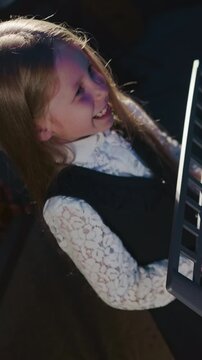 Child masters craft of vocal with mentor. Tiny girl student refines singing abilities with instructor playing synthesizer upper view. Musical development