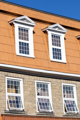 Facade of a residential building. External house wall with windows.