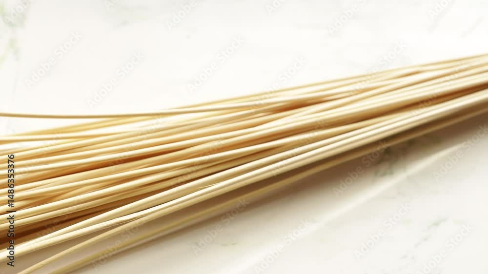 Poster a collection of bamboo sticks arranged on a flat surface, great for various uses such as decoration 