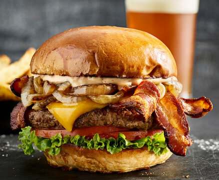 Bacon cheeseburger with fries and beer