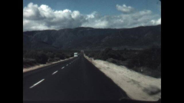 Passing on a Desert Highway 1968 - First person view from a car as it passes by an oncoming camper truck in Arizona, 1968. 