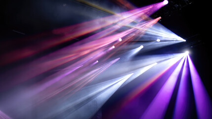 Vivid stage lights cutting through darkness, creating dramatic beams and color