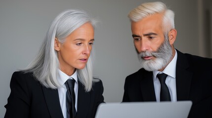 Busy executive managers in discussion over financial documents while collaborating on project planning